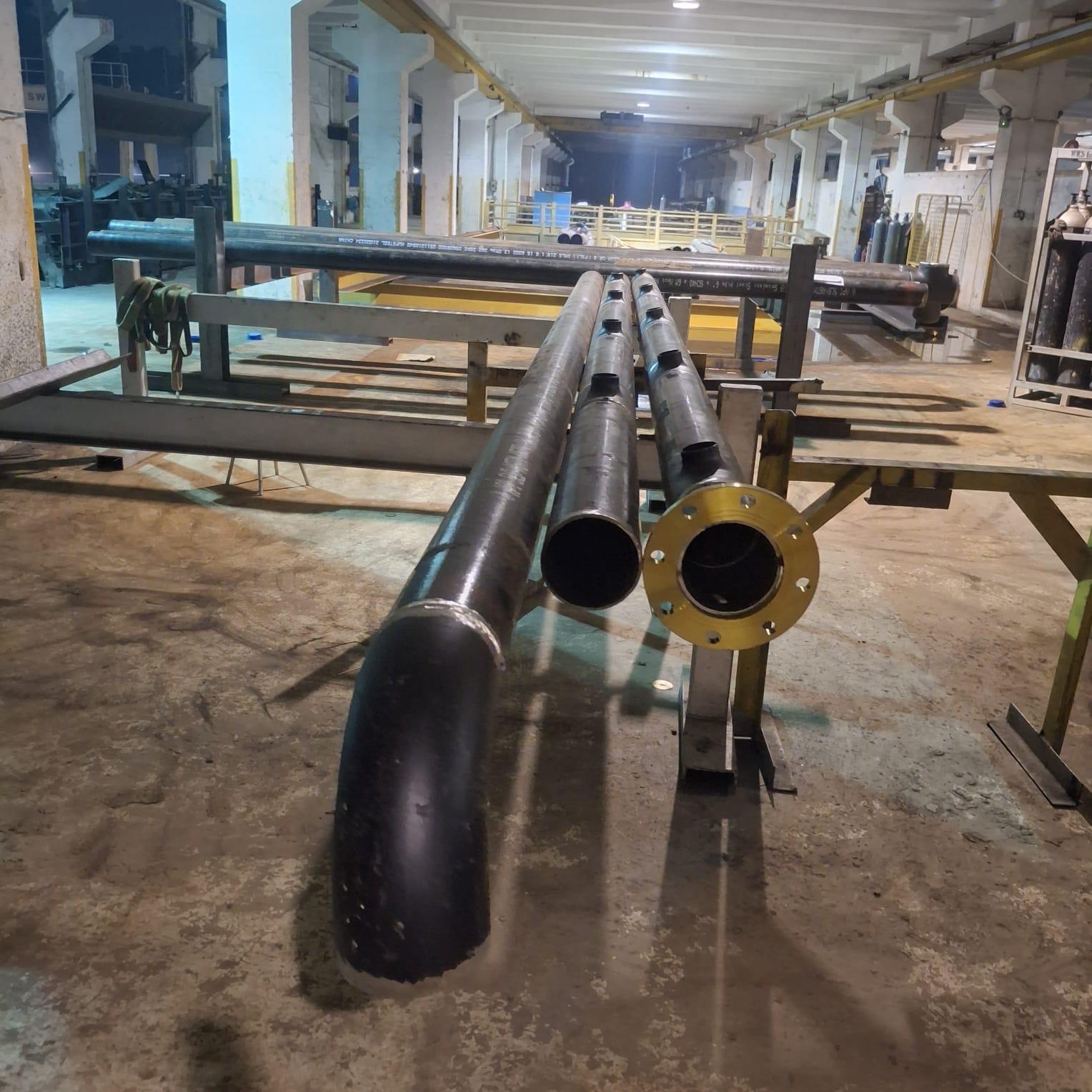 Butt-welded carbon steel pipe spools with forged flanges