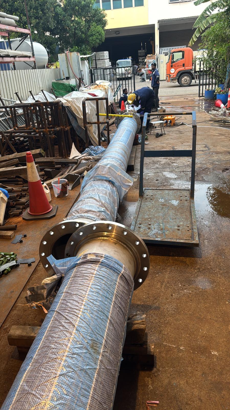 Prefabricated flanged pipe spool sections staged for hydrostatic testing